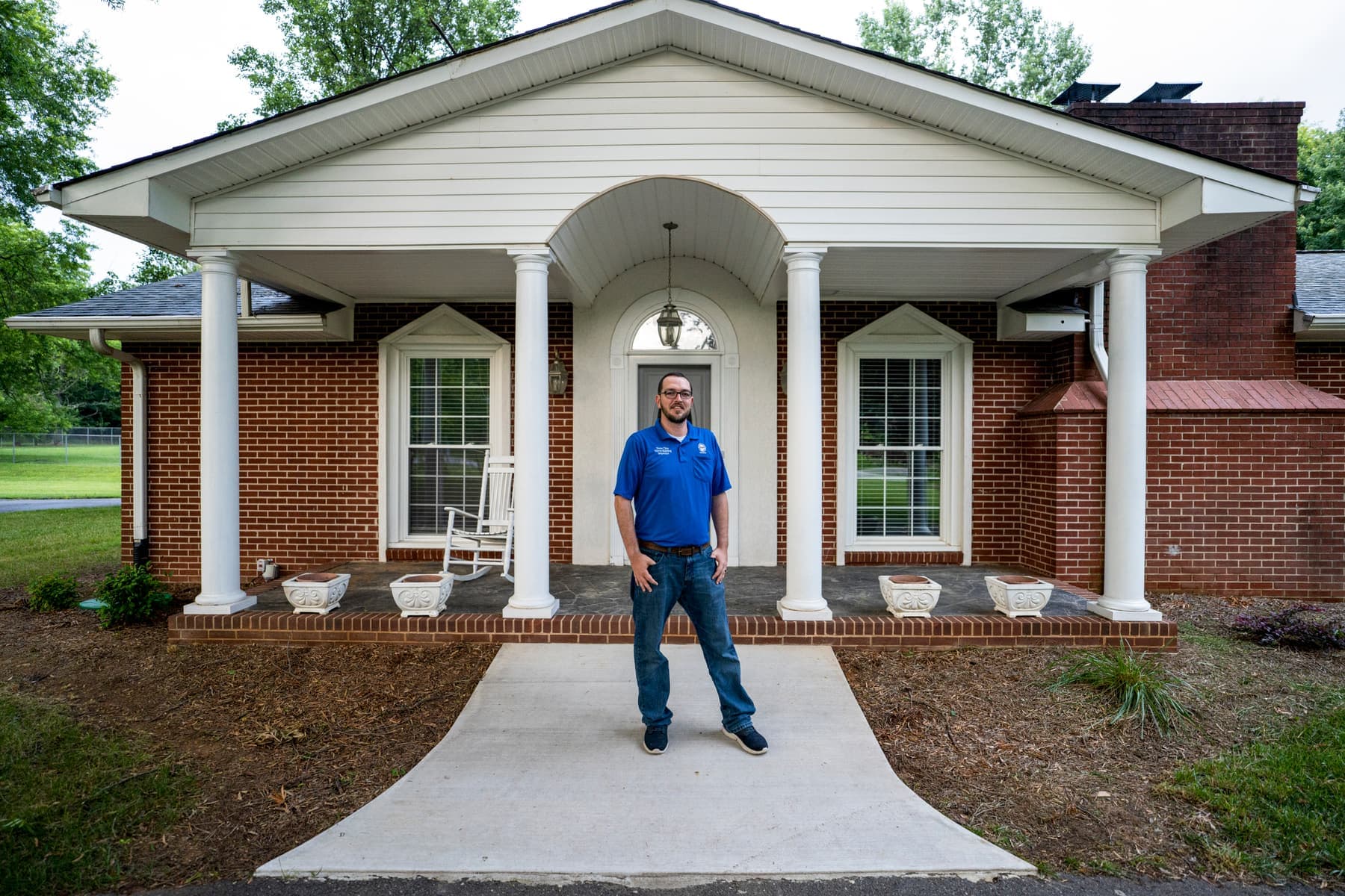 Drew Cline outside a brick ranch he inspected in the Piedmont Triad