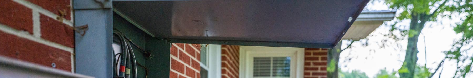 Drew Cline checking an electrical panel during a home inspection